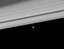 Two of Saturn's moons, Pan and Janus, coast along the outer edge of the main ring system. This image was captured by NASA's Cassini spacecraft on Aug. 22, 2008.