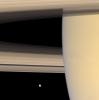NASA's Cassini spacecraft looks beyond Saturn's limb toward the icy face of Mimas, the innermost of the planet's major moons. This view looks toward the sunlit side of the rings from about 3 degrees below the ringplane.