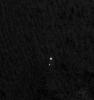 NASA's Phoenix Mars Lander can be seen parachuting down to Mars, in this image captured by the Mars Reconnaissance Orbiter. This is the first time that a spacecraft has imaged the final descent of another spacecraft onto a planetary body.