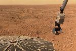 This panorama image of NASA's Phoenix Mars Lander's solar panel and the lander's Robotic Arm with a sample in the scoop. The image was taken just before the sample was delivered to the Optical Microscope.
