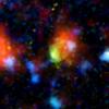 The green and red splotch in this image is the most active star-making galaxy in the very distant universe. Nicknamed 'Baby Boom,' it was spotted 12.3 billion light-years away by a suite of telescopes, including NASA's Spitzer Space Telescope. 