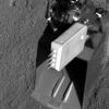 Needles of the thermal and conductivity probe on NASA's Phoenix Mars Lander were positioned into the bottom of a trench called 'Upper Cupboard.' The probe at the wrist of the robotic arm's scoop is seen after it was raised back out of the trench.