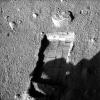 The robotic arm on NASA's Phoenix Mars Lander enlarged a trench beside a rock called 'Headless' on Sept. 20, 2008 in preparation for sliding the rock into the trench. The lander took this image later that afternoon, showing the enlarged trench.