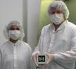 Mike Ressler (right) and Kalyani Sukhatme of NASA's JPL pose in the clean room with a model component, called a focal plane module, of the Mid-Infrared Instrument on NASA's James Webb Space Telescope.