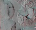 This stereo view shows fractured mounds on the southern edge of Elysium Planitia on Mars. It combines two images from NASA's Mars Reconnaissance Orbiter. 3D glasses are necessary to view this image.