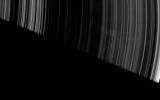 Faint, ghostly spokes dapple the dark side of Saturn's A ring as the planet's shadow makes a sharp diagonal cut across this image from NASA's Cassini spacecraft.