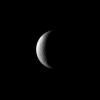 A couple of craters share a crescent of lit terrain on Saturn's moon Rhea in this image from NASA's Cassini spacecraft.