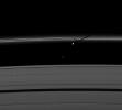 The moon Prometheus casts a shadow on Saturn's F ring near a streamer-channel it has created on the ring. The image was taken by NASA's Cassini spacecraft as the planet approached its August 2009 equinox.