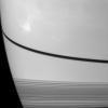 NASA's Cassini Orbiter caught the shadow of the moon Prometheus as a small dark dot on Saturn just below the narrow shadow cast by the rings in the center of this image.