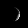 A crescent Iapetus shows, at the top right of this image from NASA's Cassini spacecraft, some of the dark terrain characterizing this unusual Saturnian moon.