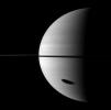 The shadow of Saturn's largest moon darkens a huge portion of the gas giant planet. Titan is not pictured here, but its shadow is elongated in the bottom right of the image.