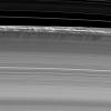 Vertical structures, among the tallest seen in Saturn's main rings, rise abruptly from the edge of Saturn's B ring to cast long shadows on the ring in this image taken by NASA's Cassini spacecraft two weeks before the planet's August 2009 equinox.