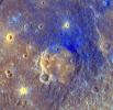 On Mercury, NASA's MESSENGER shows the smooth floor of Titian is a brighter orange color than the surrounding area, likely due to being filled with volcanic material. Ejecta from Titian appears blue.