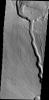This image by NASA's 2001 Mars Odyssey shows the northwestern flank of Ceraunius Tholus, one of the smaller volcanoes in the Tharsis region.Channels dissect the flank of the volcano, including a larger channel that deposited material in Rahe Crater.