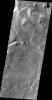 This image, taken by NASA's 2001 Mars Odyssey spacecraft, shows the western wall of Uzboi Vallis near the intersection of the vallis and Holden Crater. Many channels dissect the wall of the channel.