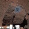 Perched on a rippled Martian plain, a dark rock not much bigger than a basketball was the target of interest for NASA's Opportunity during the past two months; Opportunity's rock abrasion tool brushed dust out of the circular area.