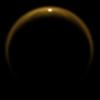 This image taken by NASA's Cassini spacecraft in 2009, shows the first flash of sunlight reflected off a hydrocarbon lake on Saturn's moon Titan. The glint off a mirror-like surface is known as a specular reflection.