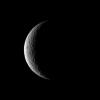 NASA's Cassini spacecraft captures a crescent of crater-covered surface on the moon Rhea. Lit terrain seen here is on the trailing hemisphere of Rhea. North on Rhea is up.