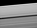 Orbiting in the Encke Gap of Saturn's A ring, the moon Pan casts a shadow on the ring in this image taken about six months after the planet's August 2009 equinox by NASA's Cassini spacecraft.