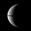 The shadow of Saturn's moon Dione, cast onto the planet, is elongated in dramatic fashion in this image captured by NASA's Cassini spacecraft. The moon itself does not appear here, but the shadow can be seen south of the ringplane.