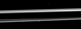 Three of Saturn's small moons straddle the rings in this image captured by NASA's Cassini spacecraft. From left to right are Pandora, Prometheus and, near the top right, Epimetheus.