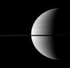 Nearly invisible upon first glance, Saturn's moon Enceladus is a small bright dot beyond the planet's rings in this image taken by NASA's Cassini spacecraft.