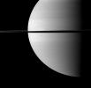The shadow of the moon Enceladus darkens a small portion of the swirling clouds on Saturn in this image captured by NASA's Cassini spacecraft. Enceladus itself is not visible in this view.