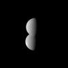 Looking like half of a figure eight, two of Saturn's moons appear conjoined in this image from NASA's Cassini spacecraft. The moon Dione, at the top in the image, is actually closer to the spacecraft, appearing to blend seamlessly with the moon Rhea.