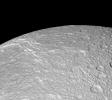 NASA's Cassini spacecraft looks across the surface of Saturn's moon Dione and details the 'wispy' terrain first chronicled by Voyager. This fractured terrain covers the trailing hemisphere of Dione.