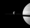 NASA's Cassini spacecraft views Saturn with a selection of its moons in varying sizes. Also seen here are Titan (center), Enceladus (far right), Pandora, barely detectable as a speck on the far left, has been brightened by a factor of two.