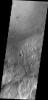 This image, taken by NASA's 2001 Mars Odyssey spacecraft, shows a portion of the rim and floor of Gale Crater. The crater rim is dissected by a channel, and dunes are located on the floor at the rim margin.
