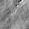 This image captured by NASA's Mars Odyssey orbiter shows a Martian pit feature on the slope of an equatorial volcano named Pavonis Mons, appears to be a skylight in an underground lava tube.