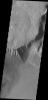 This image from NASA's Mars Odyssey shows the southeast flank of Olympus Mons. This huge volcano is surrounded by an escarpment, a large cliff at the volcano margin; a landslide lies alongside the escarpment.