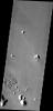 In this image from NASA's Mars Odyssey the majority of the surface appears uniform with a few small hills, the region of fractured blocks sticks out as 'something different,' perhaps remnants of crater ejecta, or an area of a different type of rock.