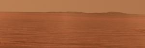NASA's Mars Exploration Rover Opportunity used its panoramic camera to record this eastward horizon view. A portion of Endeavour Crater's eastern rim, in the distance, is visible over the Meridiani plain.