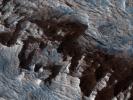 This image from NASA's Mars Reconnaissance Orbiter shows an area of layered deposits in Candor Chasma. Sheets and dunes of dark-toned sand cover the light-toned, layered bedrock.