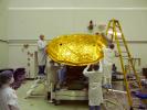 Aquarius 2.5 meter composite reflector being fitted with gold foil covering in the clean room at NASA's Jet Propulsion Laboratory in Pasadena, Calif.
