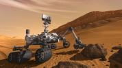 This artist concept features NASA's Mars Science Laboratory Curiosity rover, a mobile robot for investigating Mars' past or present ability to sustain microbial life. The rover examines a rock on Mars with a set of tools at the end of the rover's arm.