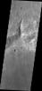 This small channel dissects the rim of an unnamed crater north of Terby Crater and Hellas Planitia as seen by NASA's 2001 Mars Odyssey spacecraft.