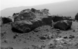 This view from NASA's Mars Exploration Rover Opportunit is dominated by a rock informally named 'Ridout' on the northeastern rim of Odyssey. The rock is roughly the same size as the rover, 4.9 feet (1.5 meters) long.