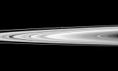 NASA's Cassini spacecraft looks across Saturn's rings and finds the moon Prometheus, a shepherd of the thin F ring. Prometheus looks like a small white bulge near the F ring -- the outermost ring seen here -- above the center of the image.