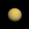 Titan's atmosphere makes Saturn's largest moon look like a fuzzy orange ball in this natural color view from NASA's Cassini spacecraft. Titan's north polar hood is visible at top, and a faint blue haze also can be detected above the south pole at bottom.