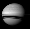 Even in a peaceful looking scene such as this one of Saturn and its moon Tethys, NASA's Cassini spacecraft reveals clues about how Saturn is ever-changing; scars are seen here of the huge storm that raged through much of 2011.