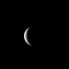 NASA's Cassini spacecraft captures Saturn's moon Rhea at crescent phase, a view never visible from Earth. Near the terminator, a few of Rhea's many craters show up in sharp relief.