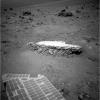 Part of NASA's Mars Exploration Rover Opportunity's array of photovoltaic cells is visible in the foreground of this image. Opportunity took this picture showing a light-toned rock, 'Tisdale 2,' on sol 2,690 (Aug. 18, 2011).