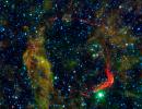 Infrared images from NASA's Spitzer Space Telescope and Wide-field Infrared Survey Explorer are combined in this image of RCW 86, the dusty remains of the oldest documented example of an exploding star, or supernova.