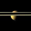 Saturn's rings obscure part of Titan's colorful visage in this image from NASA's Cassini spacecraft. The south polar vortex that first appeared in Titan's atmosphere in 2012 is visible at the bottom of this view.
