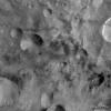 This image from NASA's Dawn spacecraft shows areas of dark material which are both associated with impact craters and between these craters on asteroid Vesta. Dark material is seen cropping out of the rims and sides of the larger craters.
