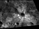 In this image from NASA's Dawn spacecraft, bright material extends out from the crater Canuleia on asteroid Vesta. The bright material appears to have been thrown out of the crater during the impact that created it.
