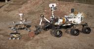 This grouping of two test rovers and a flight spare provides a graphic comparison of three generations of Mars rovers developed at NASA's Jet Propulsion Laboratory, Pasadena, Calif. The setting is JPL's Mars Yard testing area.